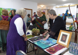 Artist June Steegstra explaining her work with Quilt and Fiber Art Museum Director Amy Green